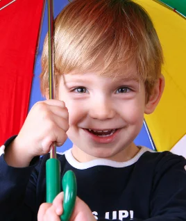 Image Of Boy Holding Multicolour Umbrella